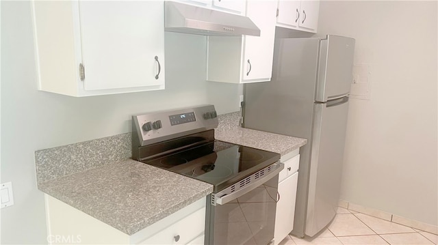 kitchen featuring light tile patterned flooring, white cabinets, refrigerator, and stainless steel electric stove