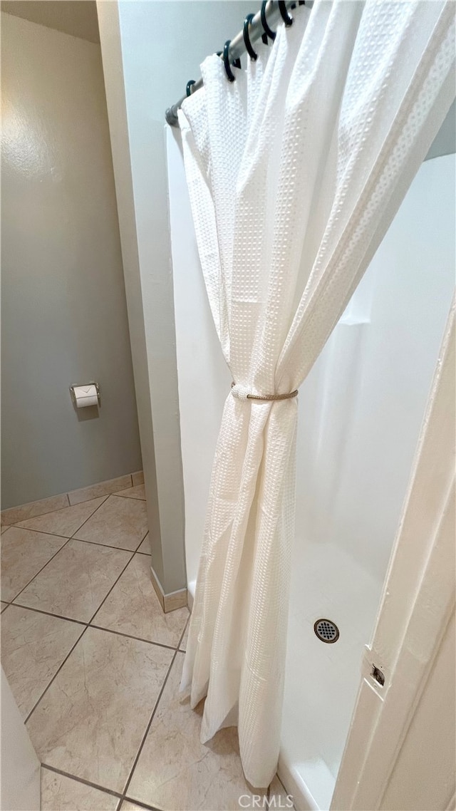 bathroom with tile patterned flooring and a shower with curtain