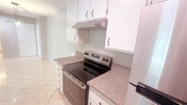 kitchen featuring appliances with stainless steel finishes, light tile patterned floors, and white cabinetry