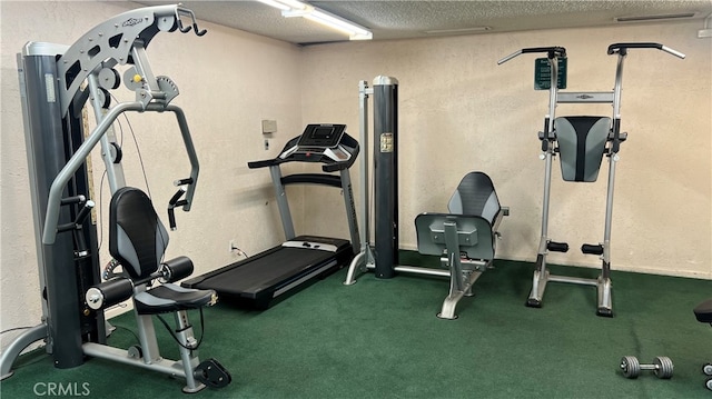 exercise area featuring a textured ceiling