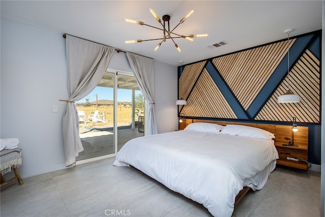 bedroom featuring access to exterior, a notable chandelier, and concrete flooring