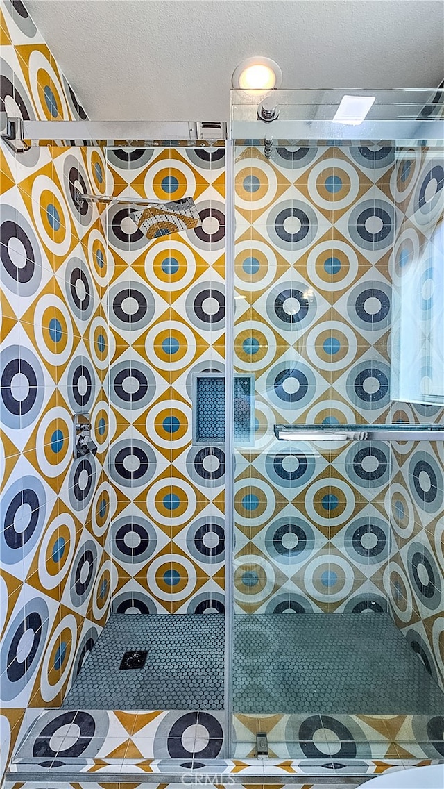 details featuring walk in shower and a textured ceiling