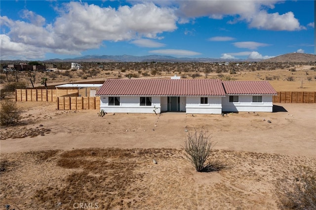 back of property with a mountain view