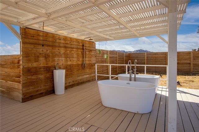 wooden terrace with a mountain view and a pergola