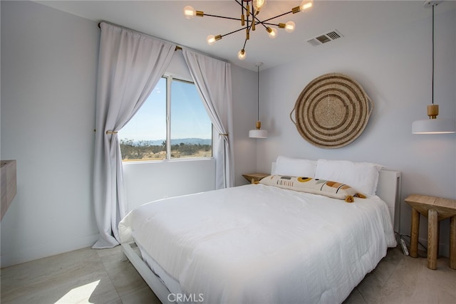 bedroom with a notable chandelier