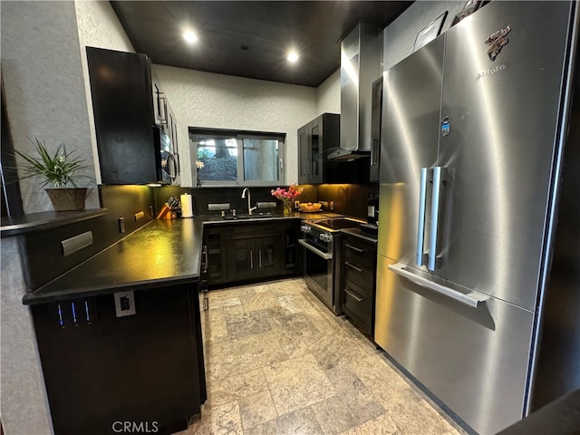 kitchen featuring stainless steel appliances, sink, wall chimney range hood, and decorative backsplash