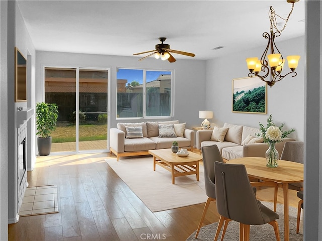 living room featuring hardwood / wood-style floors and ceiling fan with notable chandelier