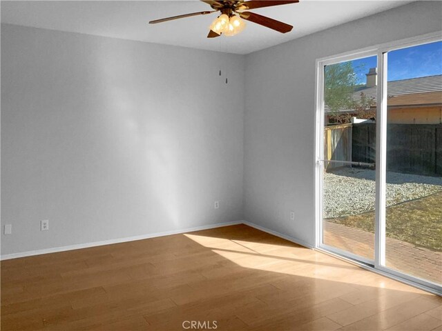 empty room with wood-type flooring and ceiling fan