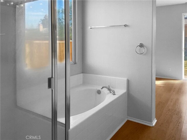 bathroom featuring hardwood / wood-style floors and shower with separate bathtub