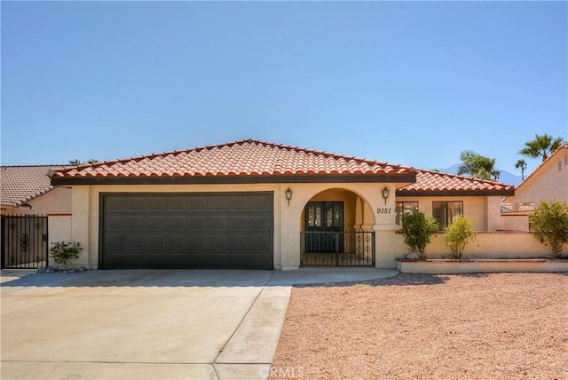 mediterranean / spanish house featuring a garage