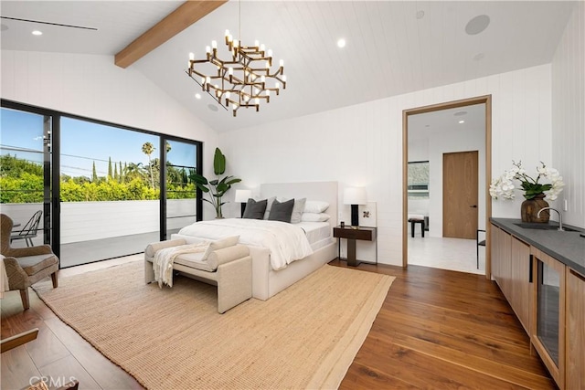 bedroom featuring access to outside, sink, a notable chandelier, beamed ceiling, and dark hardwood / wood-style floors