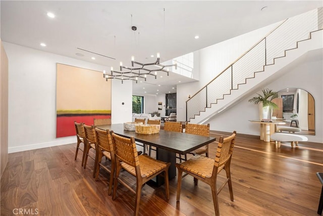 dining area with hardwood / wood-style flooring and a high ceiling