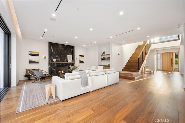 living room with light hardwood / wood-style floors and a premium fireplace