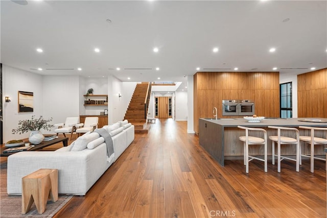 living room featuring light hardwood / wood-style floors and sink