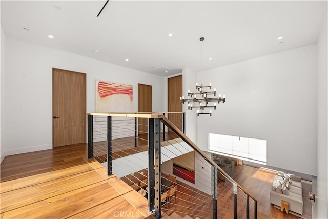 stairway with hardwood / wood-style floors