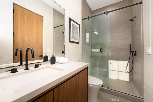 bathroom featuring an enclosed shower, vanity, and toilet