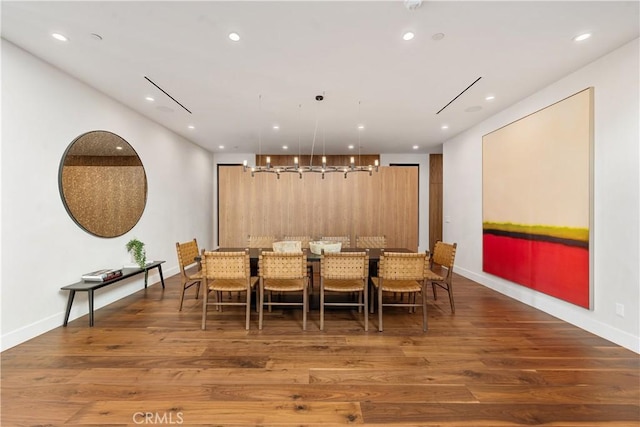 dining room with dark hardwood / wood-style flooring