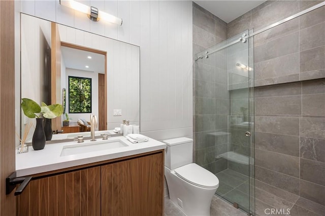 bathroom featuring vanity, toilet, and walk in shower