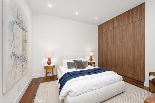 bedroom featuring dark hardwood / wood-style flooring