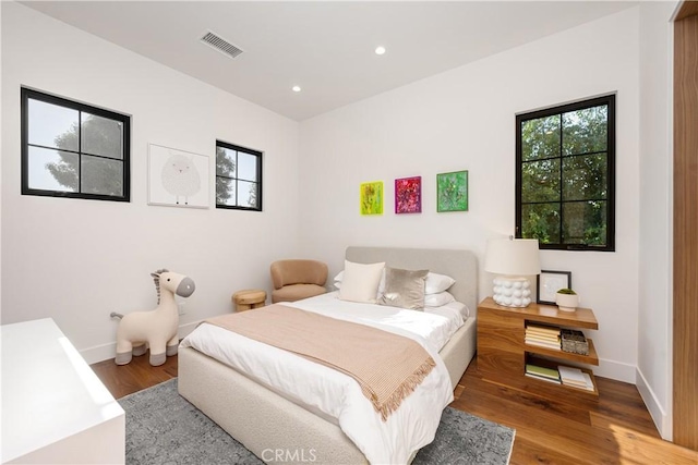 bedroom with dark wood-type flooring