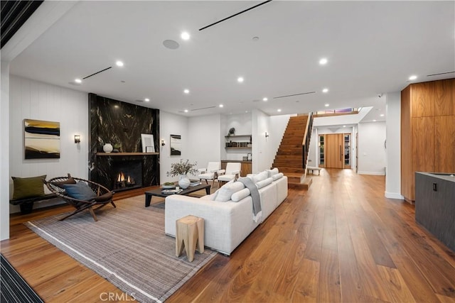 living room with a fireplace and light hardwood / wood-style floors