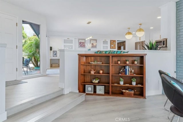 interior space with decorative light fixtures and light hardwood / wood-style flooring