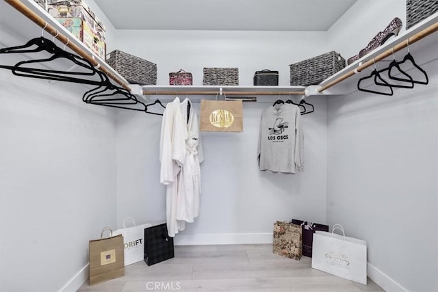 spacious closet featuring light hardwood / wood-style floors