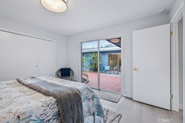 bedroom featuring access to outside, a closet, and light wood-type flooring