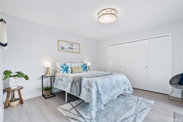 bedroom featuring a closet and light wood-type flooring