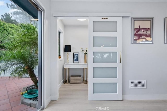 corridor featuring light hardwood / wood-style flooring