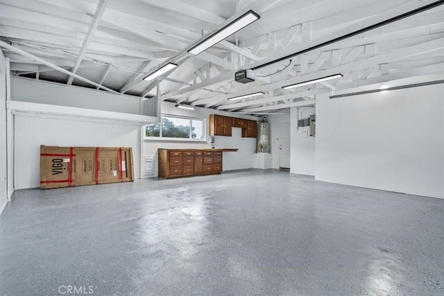 garage featuring a garage door opener and water heater