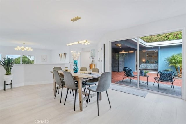 dining area with a notable chandelier and light wood-type flooring