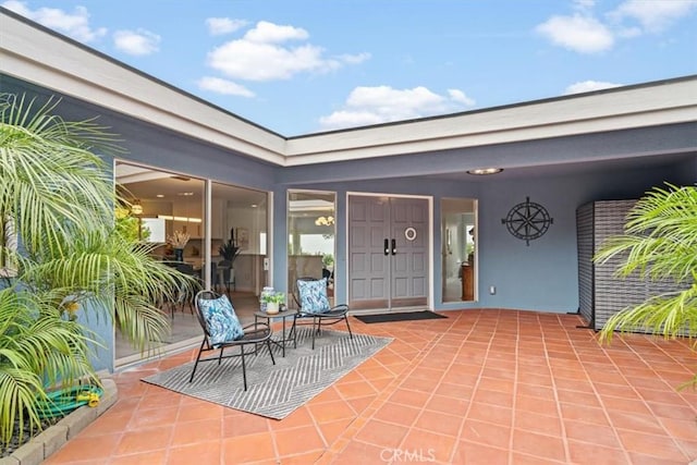 entrance to property featuring a patio