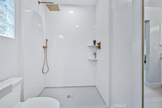 bathroom with a shower and toilet