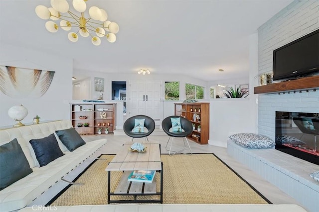 living room featuring an inviting chandelier and a fireplace