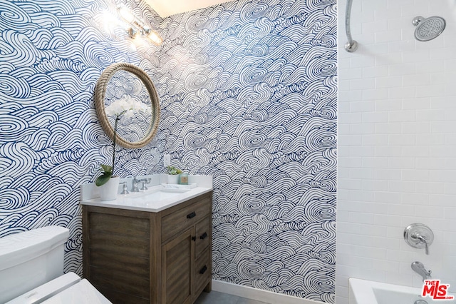 full bathroom with vanity, toilet, and tiled shower / bath