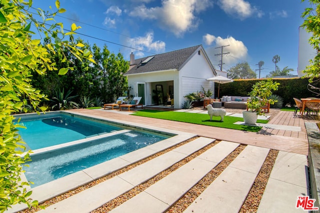 view of pool featuring an outdoor living space, a patio, and an outdoor structure