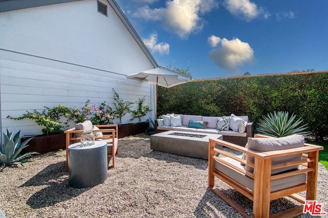 view of patio / terrace featuring an outdoor living space with a fire pit