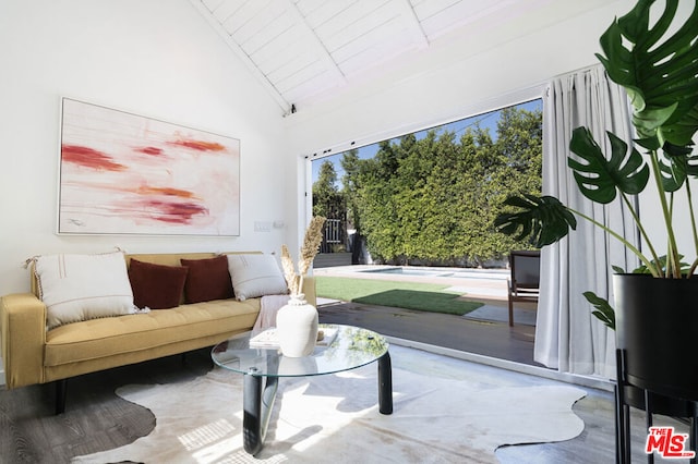 living room featuring wood-type flooring, high vaulted ceiling, and wooden ceiling