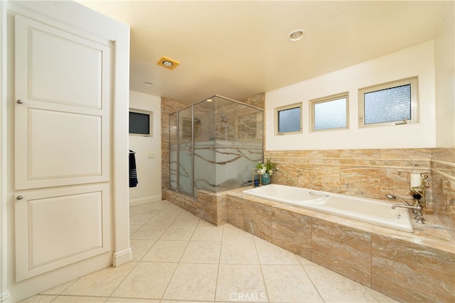 bathroom featuring tile patterned floors and independent shower and bath