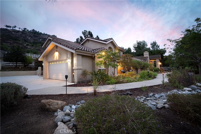 property exterior at dusk with a garage