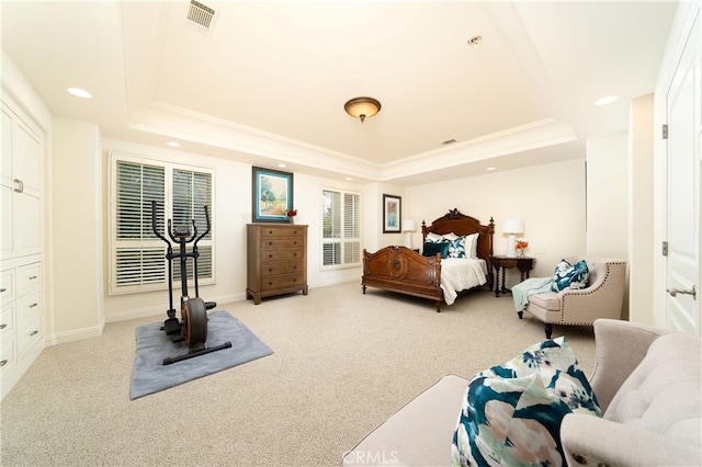 carpeted bedroom with a raised ceiling and ornamental molding