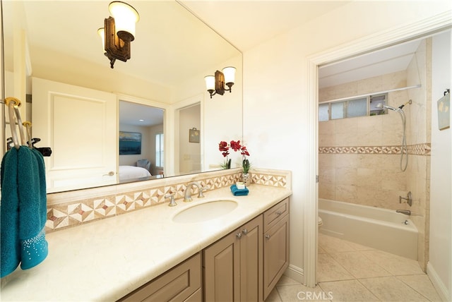 full bathroom featuring vanity, tiled shower / bath combo, tile patterned flooring, and toilet