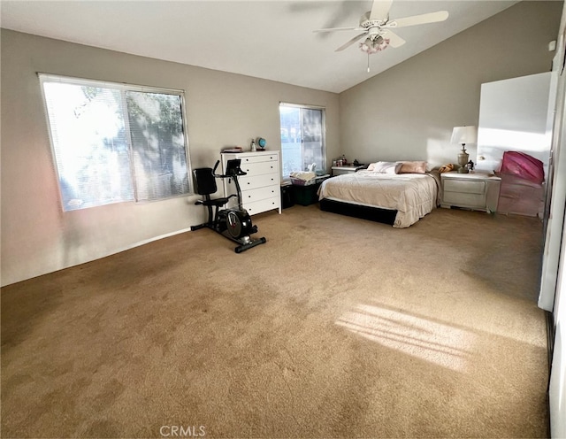 carpeted bedroom with multiple windows, ceiling fan, and vaulted ceiling