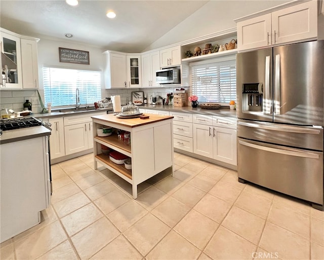 kitchen with white cabinets, appliances with stainless steel finishes, sink, and a wealth of natural light