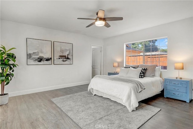 bedroom with ceiling fan and hardwood / wood-style flooring