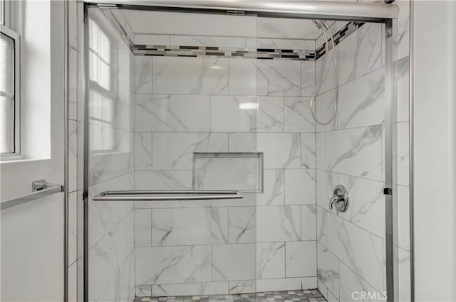 bathroom with a shower with shower door