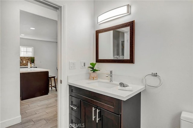 bathroom with toilet and vanity