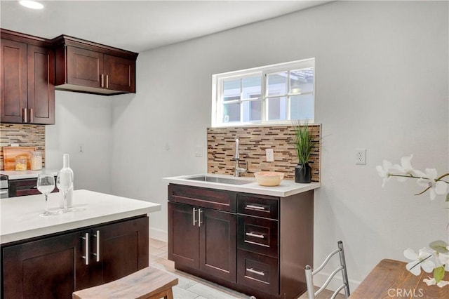 kitchen featuring sink, light tile patterned floors, and tasteful backsplash