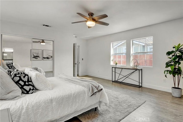 bedroom with ceiling fan and light hardwood / wood-style flooring